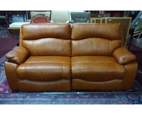 A contemporary electronic reclining tan leather sofa 