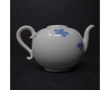A Chinese blue and white miniature teapot, decorated with petals, bearing label for Peer Groves Collection to base, H.6 W.11.