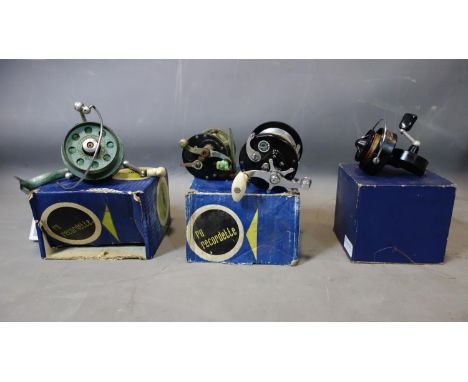 Four vintage fishing reels to include a Mitchell cap 304, a pflueger inter ocean 1885, an ocean city 143 and a Caribe 