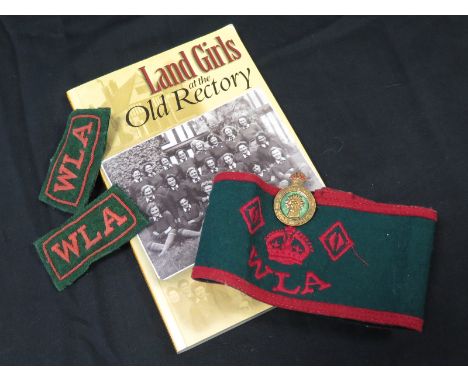 Womans Land Army items inc Arm Band, pin badge, shoulder titles and book 'Land Girls at the Old Rectory'.