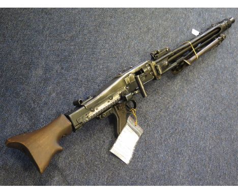 Machine Gun: A German MG42 Light machine gun cal 7.92mm. With certificate of deactivated dated 2014. Cocks and dry fires. In 