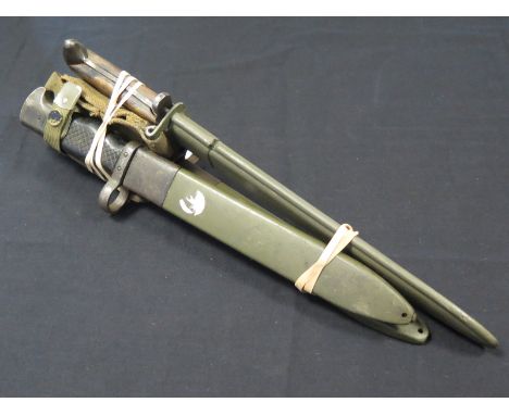 Bayonets: 1) M1 Garand Short Blade in its scabbard. Worn condition. 2) Two Spanish M1969 CETME bayonets in their plastic scab