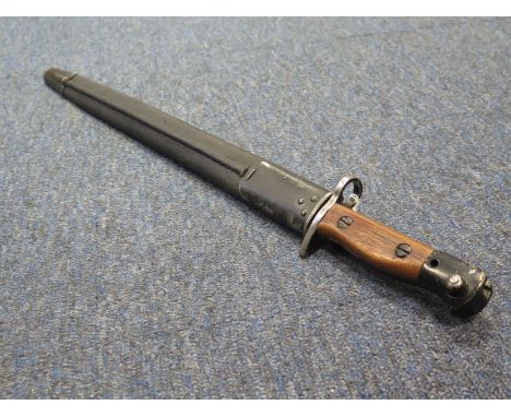 Bayonet: A P107 bayonet dated 1915. Grips replaced, worn overall. In its steel mounted leather scabbard.