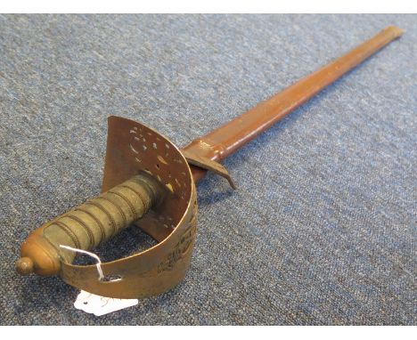 Sword: An 1897 Pattern Infantry officers sword. Plain blade 33" with some surface rust. In its leather field service scabbard