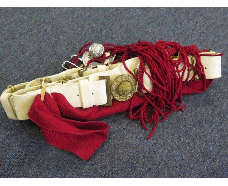 Whitened belts with brass buckles to the Irish Guards with a red sash and a modern Grenadier Guards belt. (2)