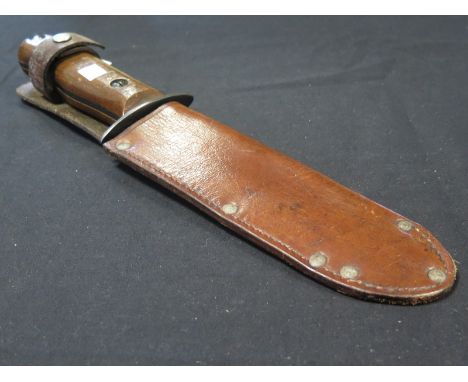 Knife: British Army Model 'D' survival knife in its leather scabbard. In good used condition. Blade 7.25". Grip and blade wit