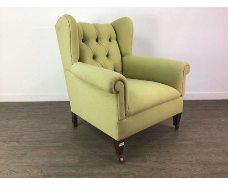 PAIR OF BUTTON BACK UPHOLSTERED WINGBACK ARMCHAIRS IN THE MANNER OF HOWARD &amp; SONS,raised on tapered front supports to cas