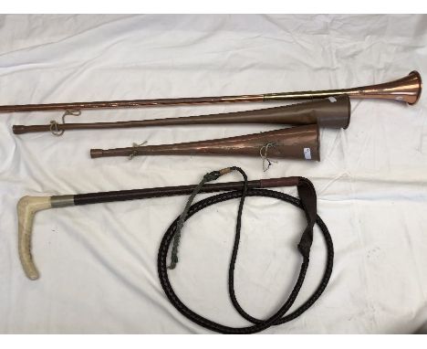 Three assorted copper hunting horns, a copper warming pan, a hunting crop and a walking stick with silver collar marked Kenda