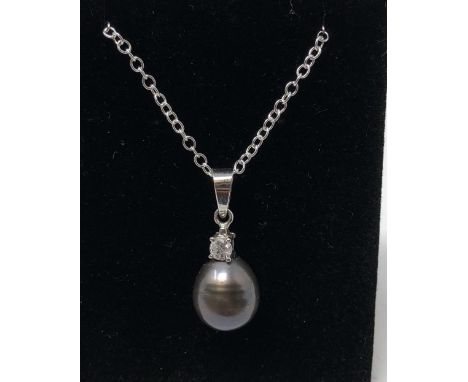 A white gold and South Sea pearl and diamond pendant necklace with silver chain.