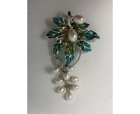 A silver and Plique A Jour brooch in the form of a leaf with pearl drops.