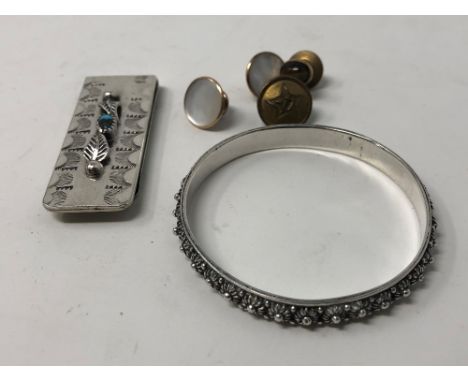 A silver plated money clip set with a turquoise, an assortment of dress studs, a tie pin set with a tiger's eye and a sterlin