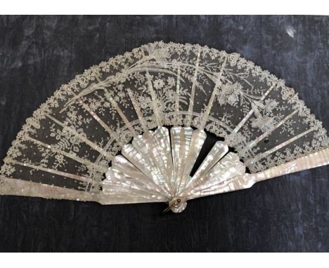 A folding fan circa 1880 possibly Belgian with mother of pearl monture, handmade lace leaf and metal loop. One stick and rib 