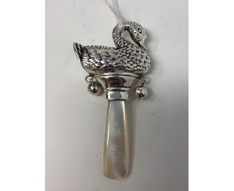 A baby's silver and mother of pearl teething rattle surmounted by a swan, marked Sterling.