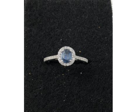 An 18ct white gold, sapphire and diamond ring, the central light blue sapphire set with approximately 1.1 carats of diamonds.