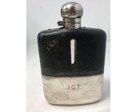 A vintage leather clad half pint hip flask.