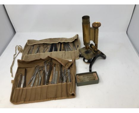 A Henry Crouch London No. 4434 cased microscope with extra lenses; also two rolls of tools including tweezers, scissors, scal