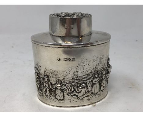 A silver tea caddy with embossed decoration depicting figures and country life. Maker George Nathan and Ridley Hayes, Chester