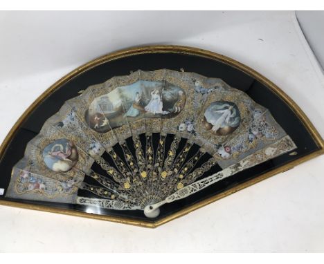 An 18th Century hand painted folding fan, possibly French. With fretted ivory monture highlighted with mother of pearl, gold 