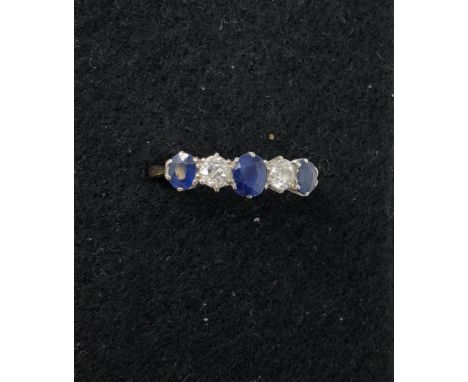 An 18ct gold and platinum five stone diamond and sapphire dress ring. Approximately 0.4ct of diamonds. Size O. Total weight a