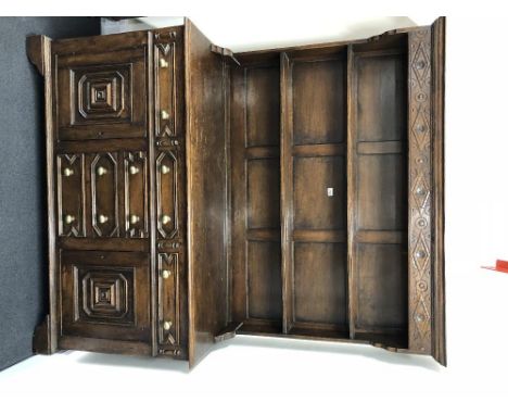 An 18th Century style oak dresser, the open plate racks above a bank of four central drawers flanked by two drawers and two c