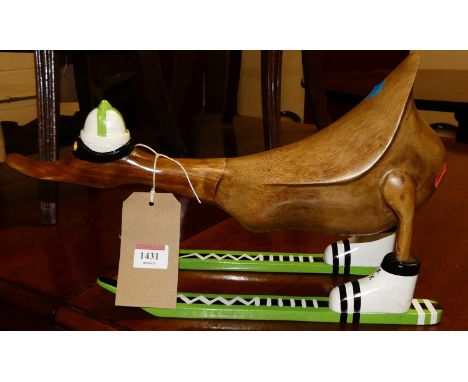 A contemporary stained hardwood novelty model of a skiing duck, length 40cm