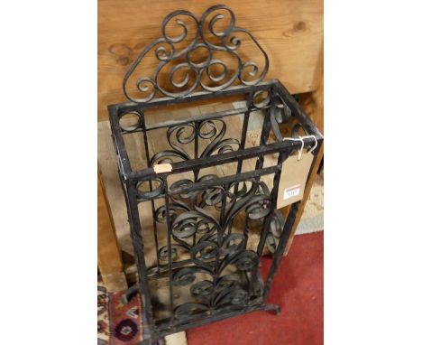 A black painted wrought iron twin division stick stand, width 42cm