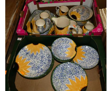 Two trays containing a quantity of hand painted Poole Pottery table wares to include dinner plates, side plates, bowls, water