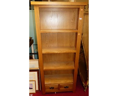 A contemporary light oak freestanding open bookshelf, having fixed shelves and two short lower drawers, w.80cmCondition repor