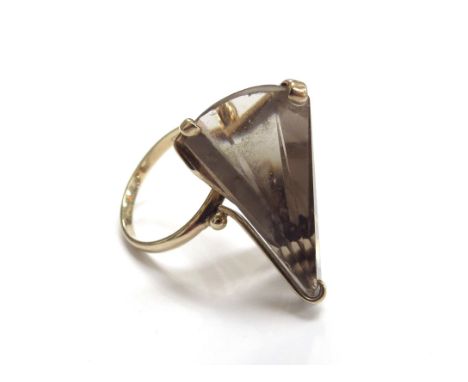 A 9ct gold abstract design ring with a facet cut smoky quartz. Size N, 6.1g