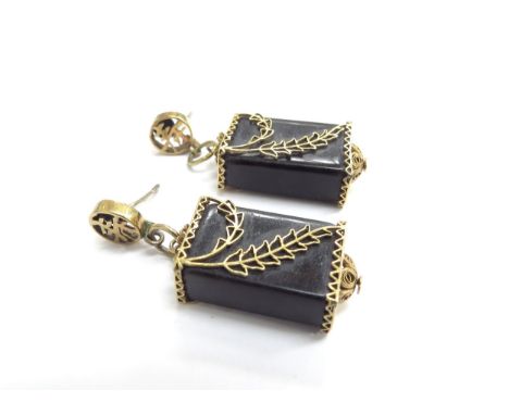 A pair of drop earrings possibly black jade with filigree and foliate decoration in gold, stamped 14k, Chinese character mark