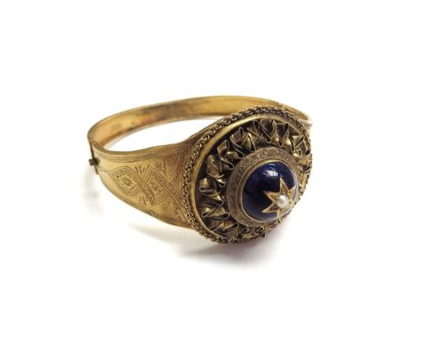 A Victorian gilt bangle with enamel and pearl star and engraved decoration, 5cm x 5.3cm