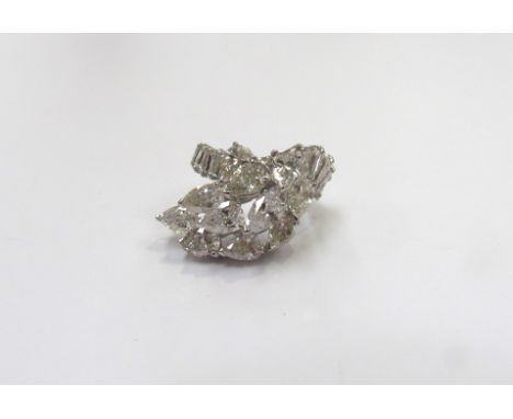 A diamond cluster ring, set with a sweep of 11 pear cut diamonds flanked by baguette cut diamond set shoulders, 6ct total app