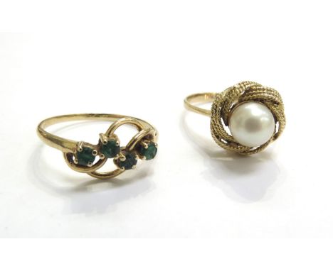 A gold ring set with four small emeralds, size P and an unmarked gold ring set with a single pearl in a swirl mount, size N, 