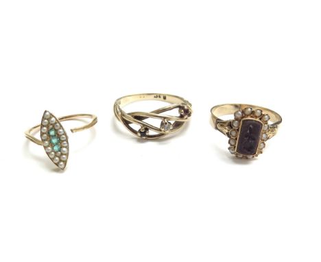 A memorial ring with flower motif, repairs present, an emerald and seed pearl ring (broken) and a 9ct gold three stone ring, 