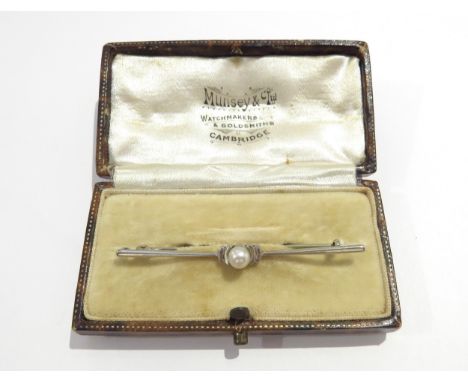 A 9ct white gold bar brooch centrally set with a single pearl, 5.8cm long, 2.1g, in fitted case