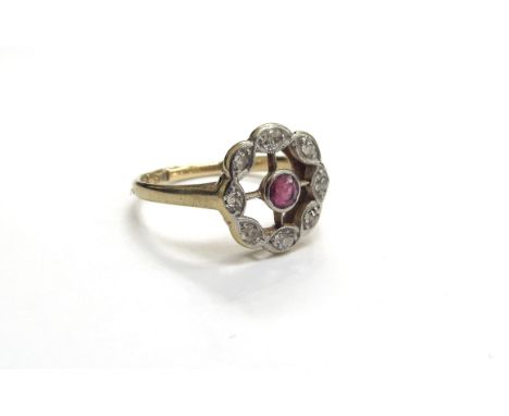 An 18ct gold ruby and diamond halo ring. Size M, 3.6g