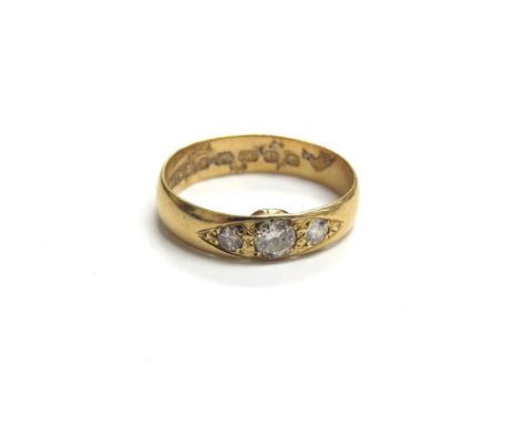 A 22ct gold ring set with three diamonds in rubover setting. Size K/L, 3g