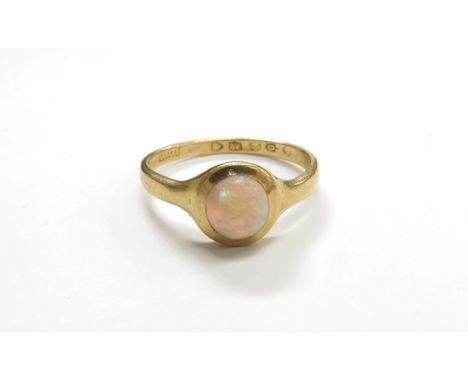 A 22ct gold ring set with a round cabochon opal. Size S, 4.6g