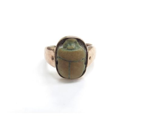 A gold ring with a swivel scarab beetle, stamped 9k. Size K, 5.7g