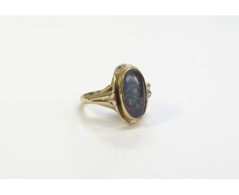 An opal ring in rubover 9ct gold mount. Size K, 3.4g