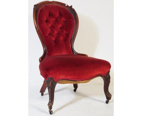 A 19th century Victorian mahogany spoon back ladies chair. The chair having a chesterfield style button back rest with a maho