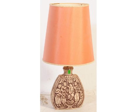 A mid 20th century carved ceramic lamp base, likely European. Modelled base in a banjo form with pictorial reference to music
