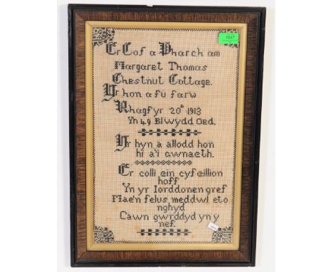 An early 20th century Edwardian mahogany framed needlepoint tapestry sampletr. The tapestry being in Welsh and dated to 1913.