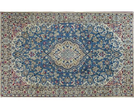 A Central Persian part silk Nain rug, central double pendent medallion with repeating spandrels on a light blue field, within