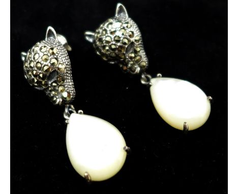 A pair of sterling silver and marcasite studded earrings in the form of leopards heads suspended by mother of pearl drops 