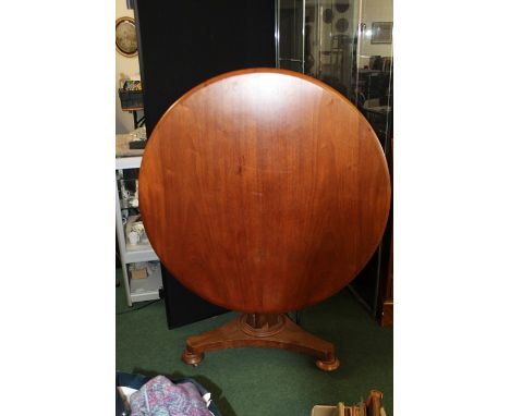 Victorian mahogany breakfast table, the circular tilt top raised on an octagonal tapering stem, plateau base and castors, 102