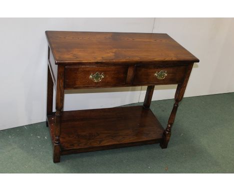 17th Century style oak side table, the rectangular top above two frieze drawers and turned supports above an undertier, 90cm 