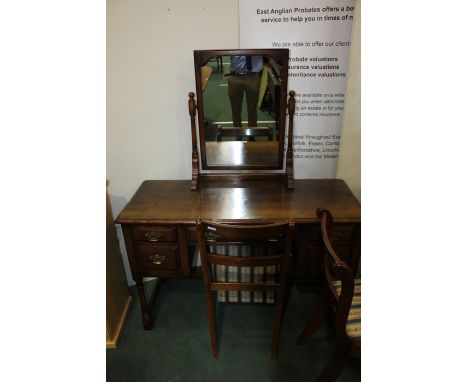 Oak dressing table, with mirror above an arrangement of five drawers, raised on turned legs and flattened stretchers, 121cm w