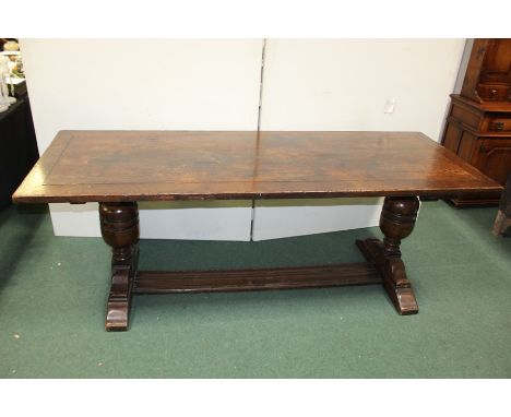 17th Century style oak refectory table, with a rectangular top above two large bulbous supports united by a stretcher, 213cm 