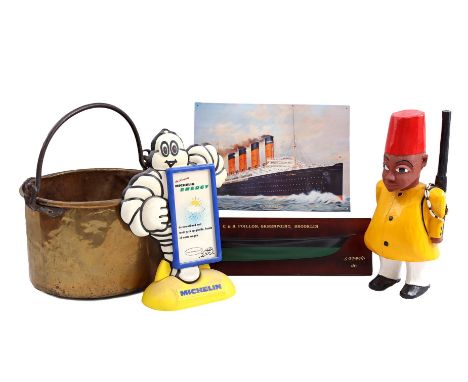Copper barge, polychrome wooden statue of man with gun, scale model boat on shelf, metal plate with ship and plastic Michelin
